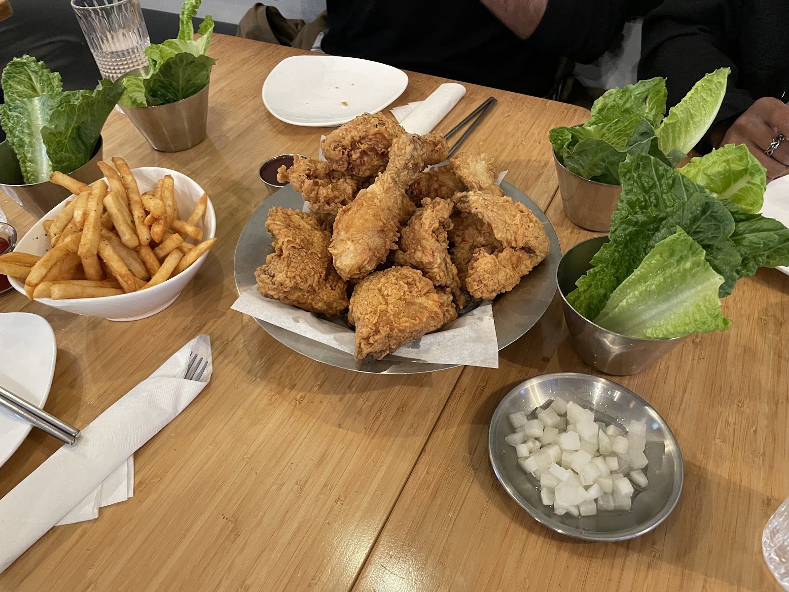Fried chicken and fries on the table with romaine and dipping sauces