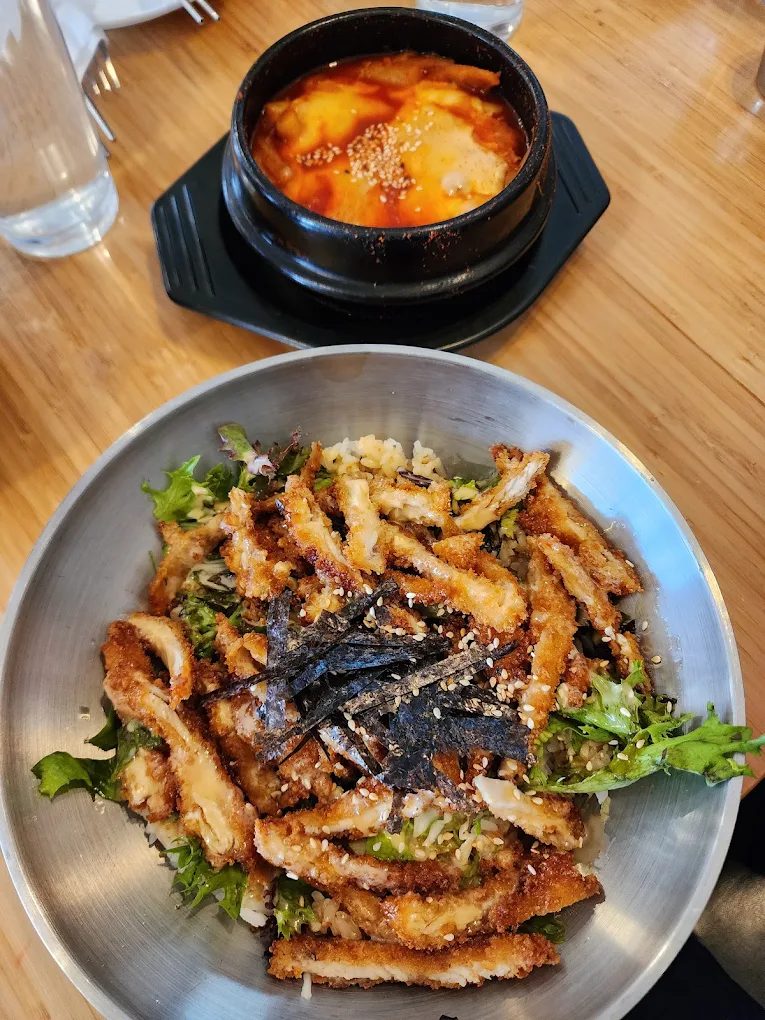 Chicken cutlet deopbap rice bowl with a stone pot of soup