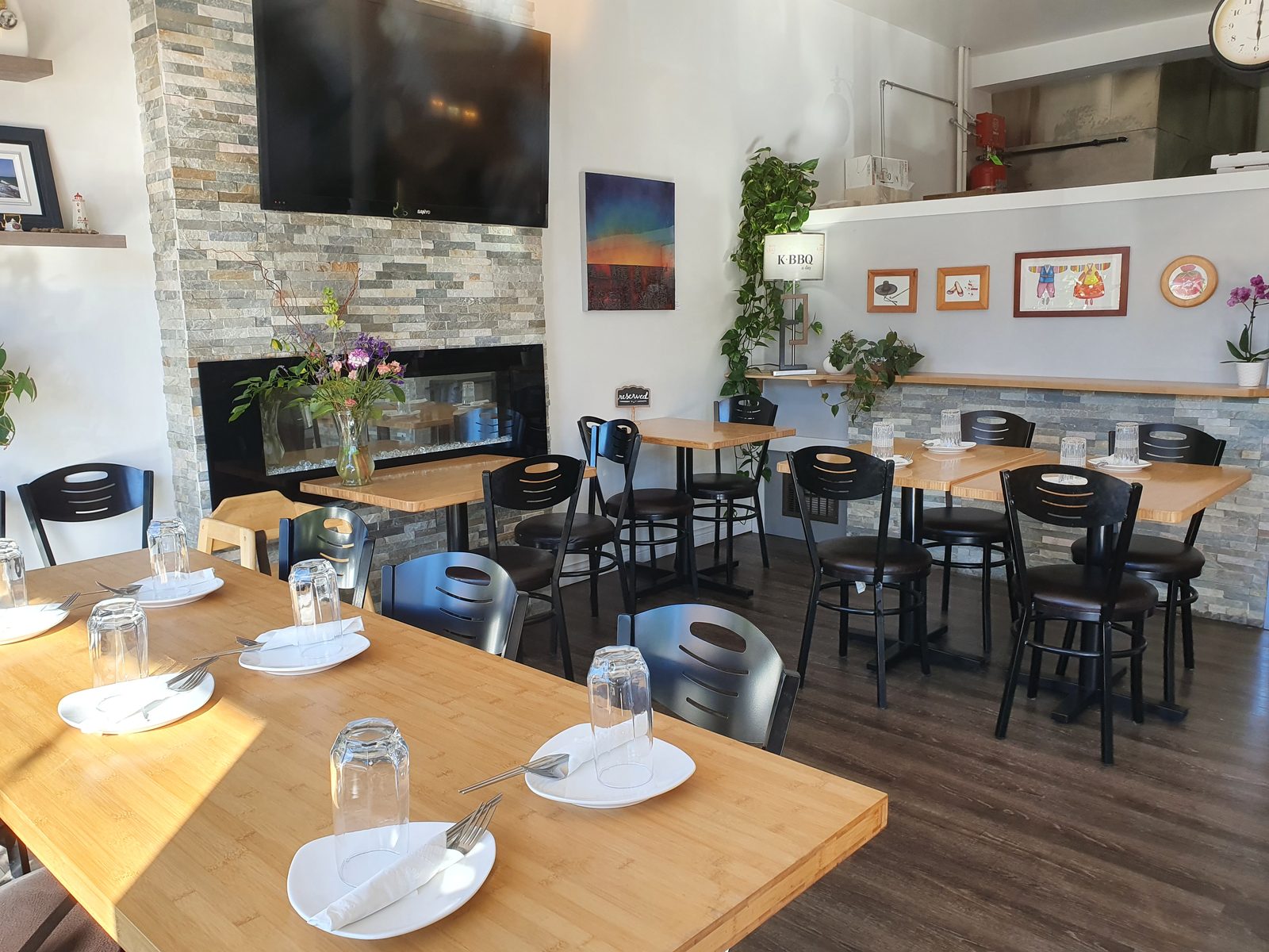 Haru's bright dining room with bamboo tables and a stone fireplace