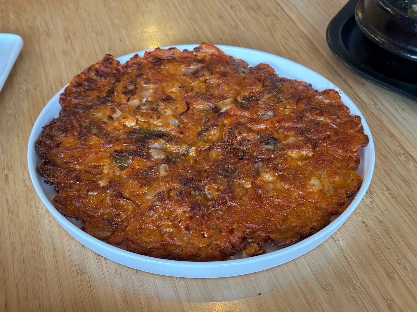 Kimchi jeon pancake on a white plate